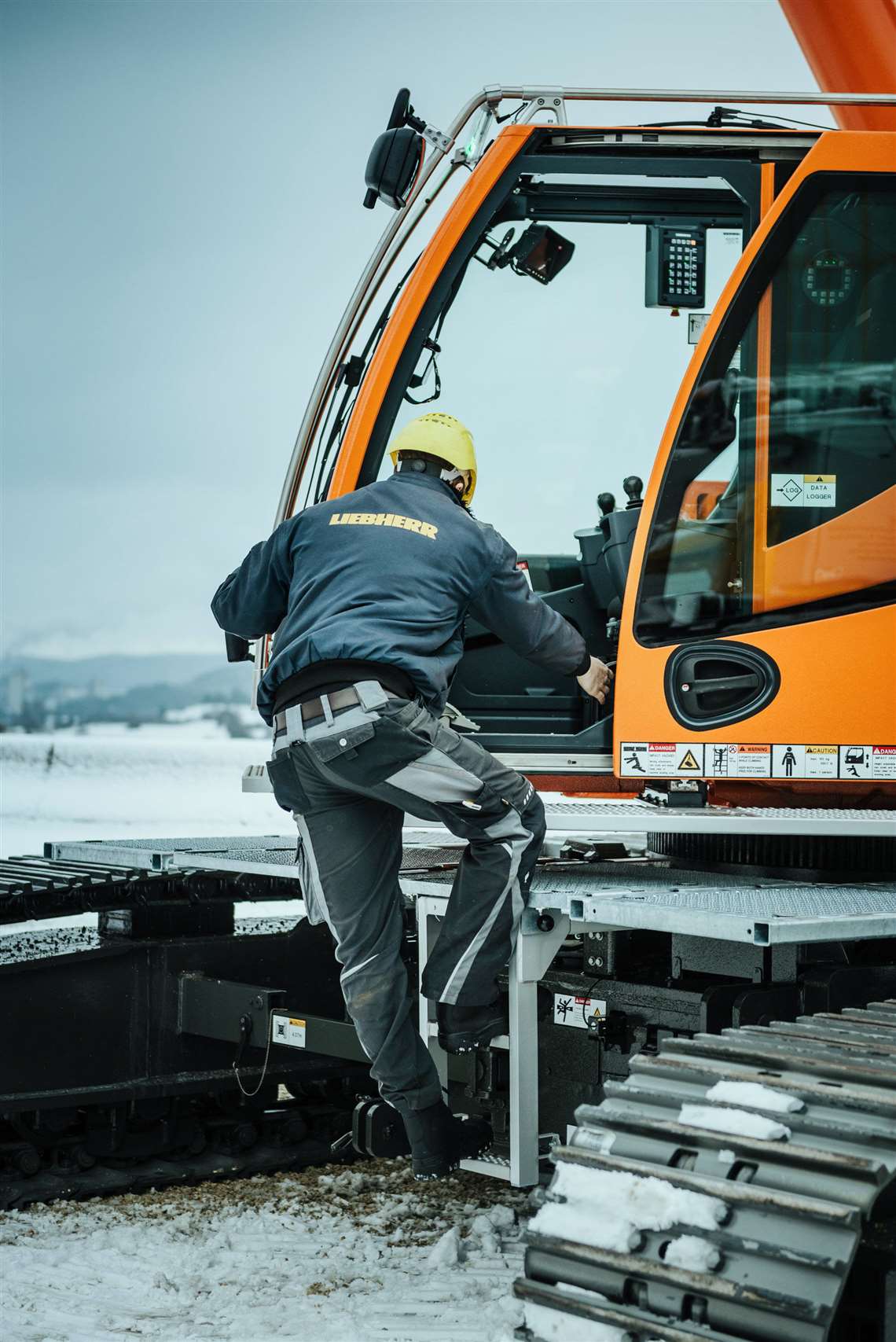 Operator entering LTR 1040 cabin via folding ladder