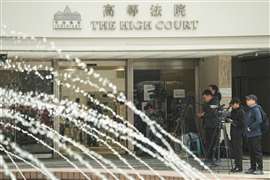 Media members stand outside the High Court where a court hearing on property developer China Evergrande Group is held, in Hong Kong, China January 29, 2024.