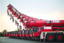 red cranes in Integrated Logistics livery lined up side by side