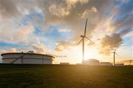 A wind turbine set against a sunrise.