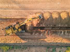 An aerial view of an excavator with a Built Robotics Exosystem doing trench work