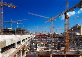 Multiple tower cranes on a construction site in Doha, Qatar