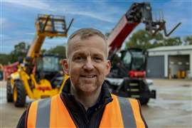 Steve Mulholland in high-vis standing in a yard in front of a couple of telehandlers