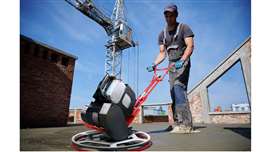 Battery-electric trowel smoothing concrete on a flat roof