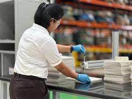A quality control techncian tests the integrity of SaveGuard's thermal management materials at its manufacturing facility in India