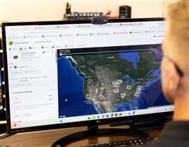 A technician monitors engines across the United States within John Deere's Connect Support platform