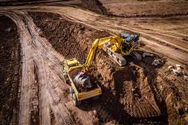 An excavator using Trimble Earthworks loads an ADT