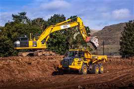 An excavator loads an ADT