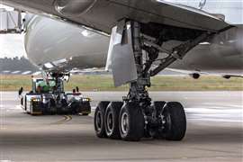 A ground support vehicle undertakes pushback operations on a wide-bodied aircraft