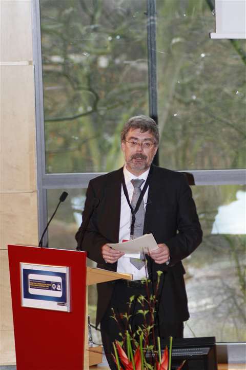 Klaus Meissner smart in front of a red box