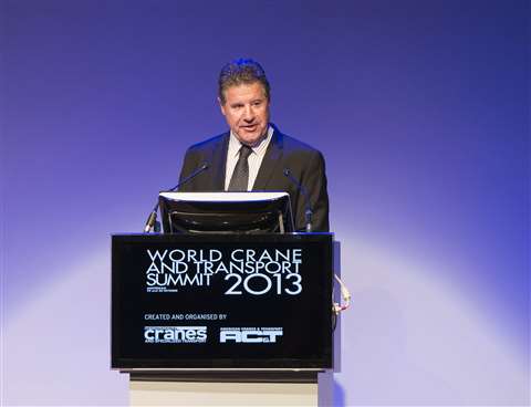 John Gillespie at a lectern blue background