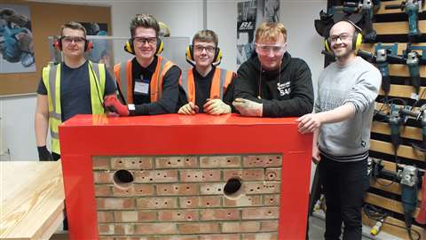 Trainee workers standing with their tools