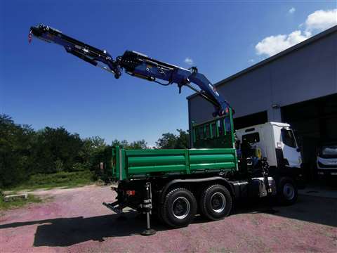 Black articulating crane on a green truck