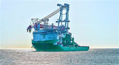 Green and white ship at sea