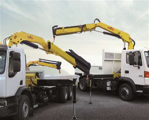 yellow cranes on trucks