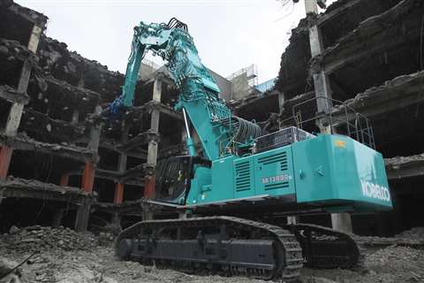 The Kobelco SK1300DLC ultra-high reach demolition machine taking down a tower block