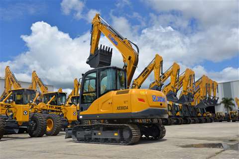 New, yellow XCMG excavators lined up at a depot.