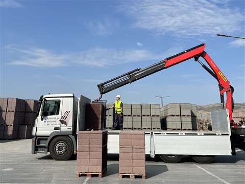 rear mounted red and black Palfinger crane in brick and block application