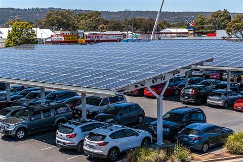 A car park with solar PV panels mounted on solar shades