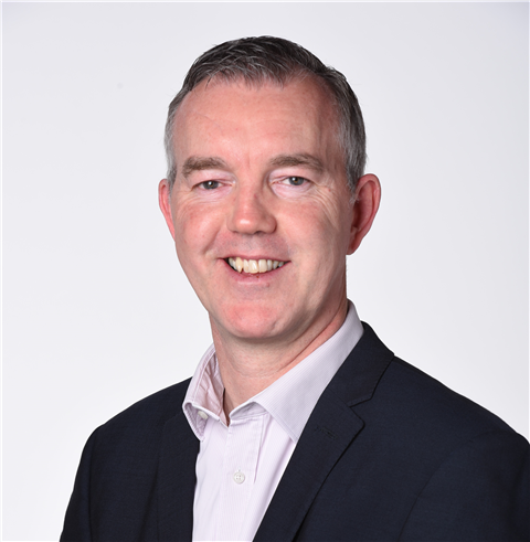 Portrait photo of Adam Hosking smiling