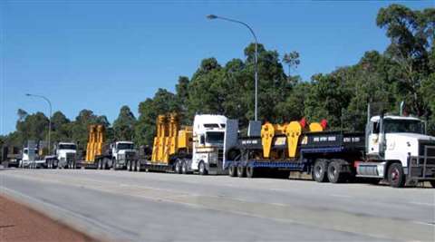 Machinery Movers' J&amp;R Engineering T1102-4-40 Lift-N-Lock hydraulic gantry sets in transit to a n