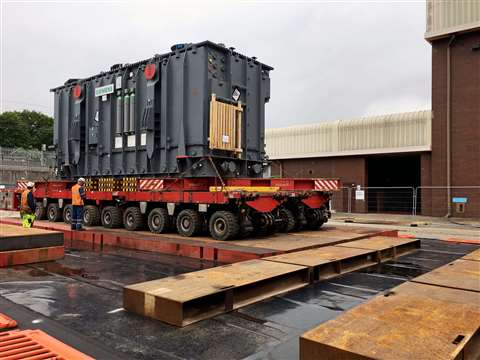 One of the two big grey box Sellindge transformers on Collett & Sons red Scheuerle SPMT with power pack