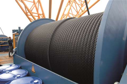 A very large blue winch drum with steel wire rope