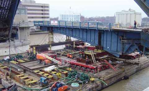 View showing the four sets of 12 lines each of self propelled modular transporters supporting a stee