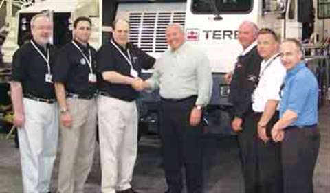 Shaking hands at ConExpo on a US$ 30 million deal are AmQuip CEO Joseph Unic's Wesley, right, and Te