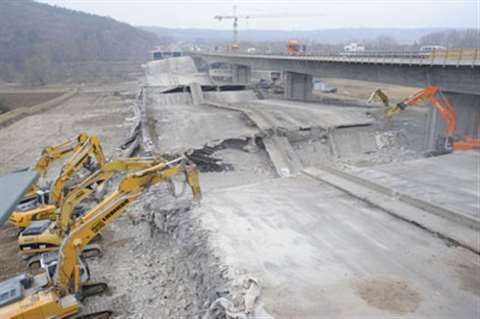 Excavators equipped with breakers and pulverisers attack the Randersacker Bridge debris