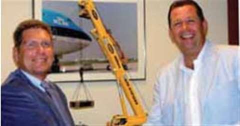 Martin Verzijl from Sarens, left, shakes hands with Jaap Schalekamp from Riwal to close the deal tha