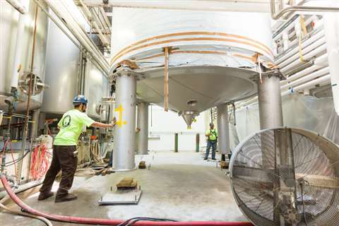 One of the tanks being lowered through the roof
