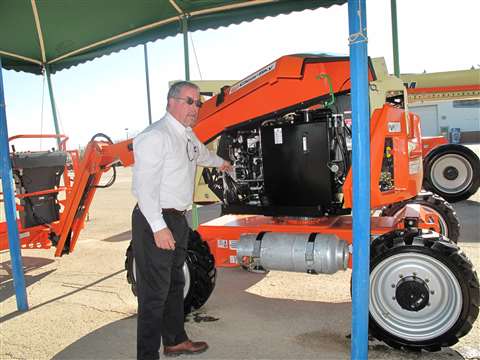 Bill Dovey, JLG"s product champion, shows ALH the 340AJ's gas/propane prototype engine. A Tier 4 die