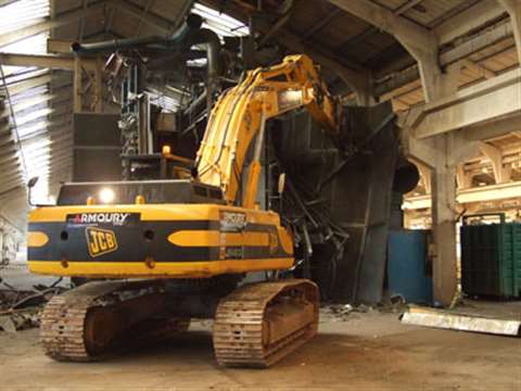 The JS 460 tackles the old shot blasting shop armed with a Demarec MQP-60.