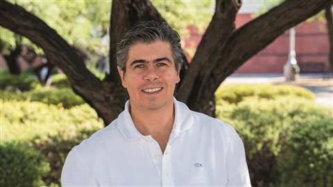 Jaime Serdan man in white shirt standing under a tree