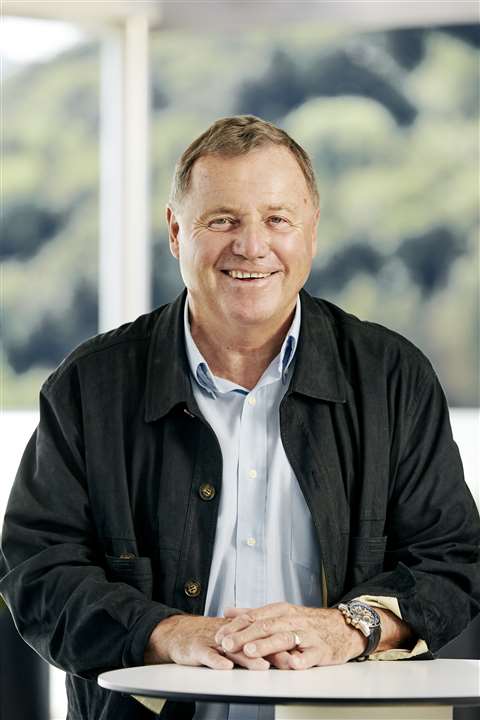 Hubert Palfinger Senior sat at a desk, casual, friendly. Photo: Palfinger AG