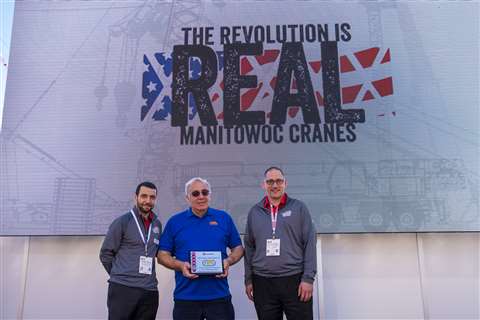 Aaron Ravenscroft and Orlando Mota of Manitowoc present the award to Nabil Al Zahlawi