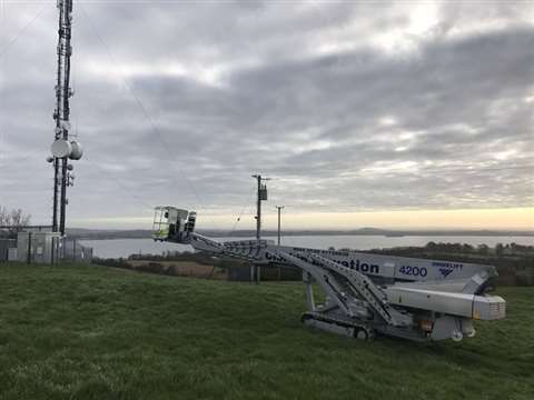 Clerkin Elevation's Ommelift 4200 RBDJ 4200 travels over rough terrain to reach a phone mast.