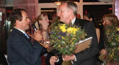 ESTA president Christian-Jacques Vernazza, left, congratulates Soren Jansen from BMS in Denmark, at 