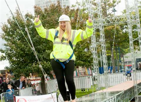 Kerri Dorman from civil engineering firm Aecom walks across the Meccano Bridge
