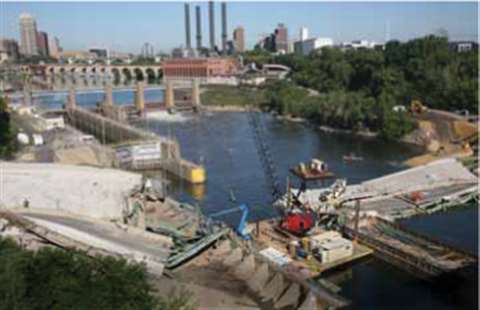 Bolander's 481 Link-Belt crawler secured to a barge in the Mississippi River removing debris from th