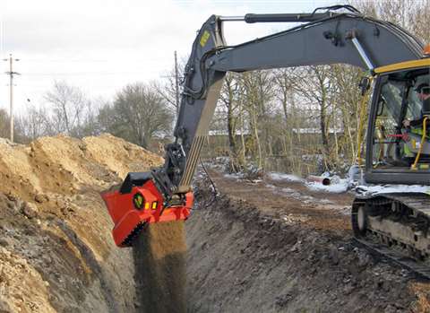 An Allu bucket backfills a pipeline trench