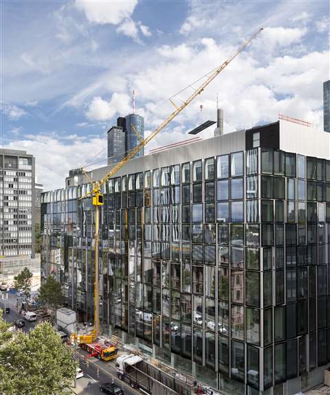 The Liebherr MK 140 mobile construction crane working on roofing in Frankfurt's banking area