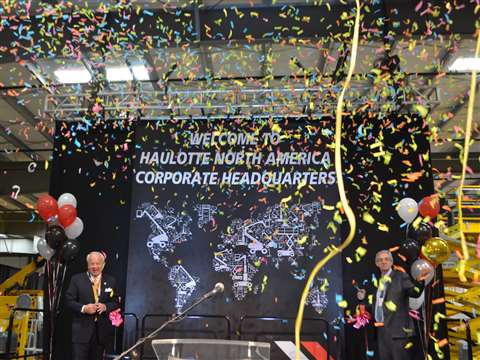 Virginia Beach mayor, William Sessoms, left, helped Alexandre Saubot, COO of Haulotte Group, right, 