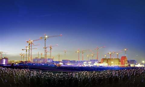 The tower cranes are illuminated during an evening entertainment at the site