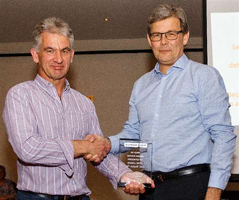 Russell Bates, MD of Alimak Hek UK receiving an award for his 40 years’ at the company from Alimak H