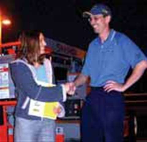 Brad Boehler of Skyjack congratulates Patricia Steadman of SteadMan Lift Systems on the successful c