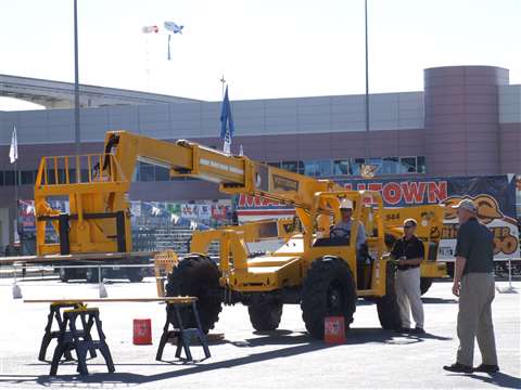 Pettibone 2009 Telehandler Skills Challenge participant Chris Natividad places 2x6 boards on saw hor