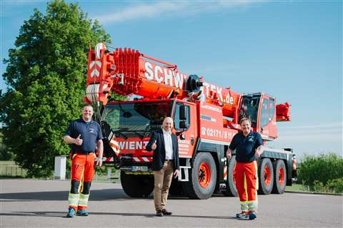 Schwientek collecting its new orange Liebherr LTM 1090-4-2 wheeled mobile telescopic crane from the factory in Germany