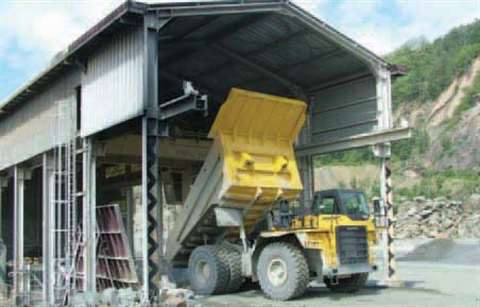 Haulers, charged by Cat loaders, carry the blasted rock to a 1300 t/hr Dragon primary crusher.